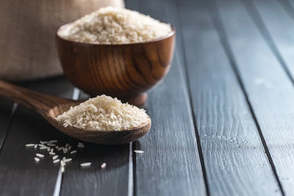 Uncooked White Rice Wooden Spoon Black Table — 图库照片