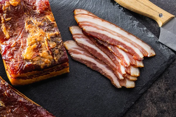 Whole Sliced Smoked Bacon Black Table Top View Stockfoto