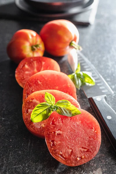 Sliced Bull Heart Tomatoes Black Table Imagen de stock