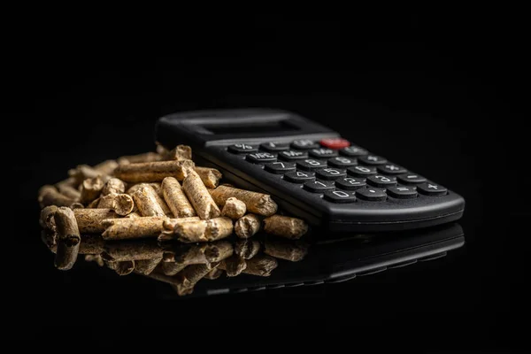 Wooden Pellets Calculator Black Background Concept Paying Heating — Fotografia de Stock