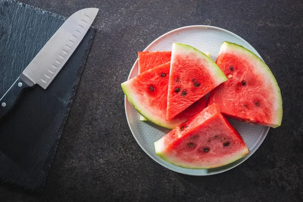 Slices Red Watermelon Knife Black Table Top View — Zdjęcie stockowe
