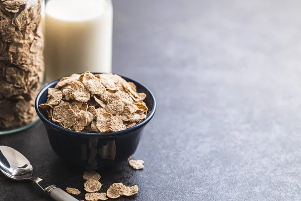 Whole grain cereal flakes. Wholegrain breakfast cereals in bowl on a kitchen table.