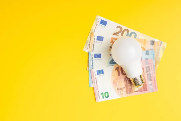 Light Bulb Euro Yellow Background Concept Increasing Electric Prices — Fotografia de Stock