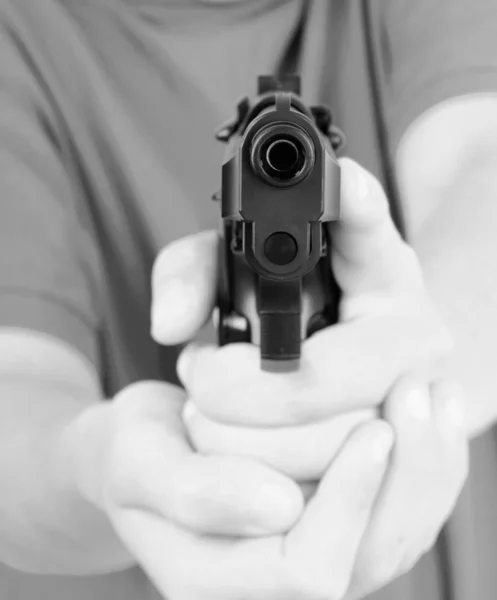 Hand with gun, short focus on the gun — Stock Photo, Image