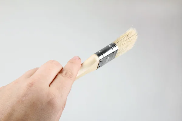 Hand with brush — Stock Photo, Image