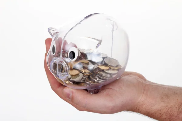 Banco porquinho em vidro com moedas na mão — Fotografia de Stock