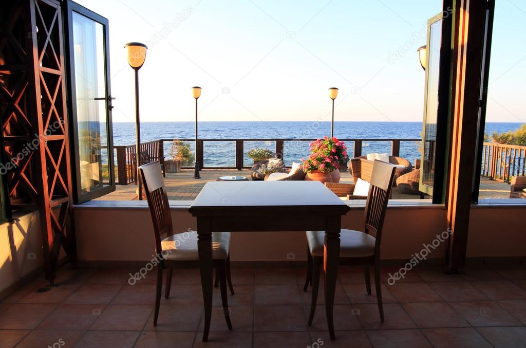 empty table in a restaurant overlooking the sea