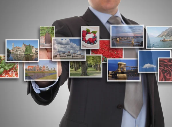 Mans hand reaching one of images streaming — Stock Photo, Image