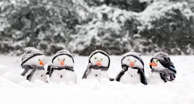Little snowmen in a group clipart