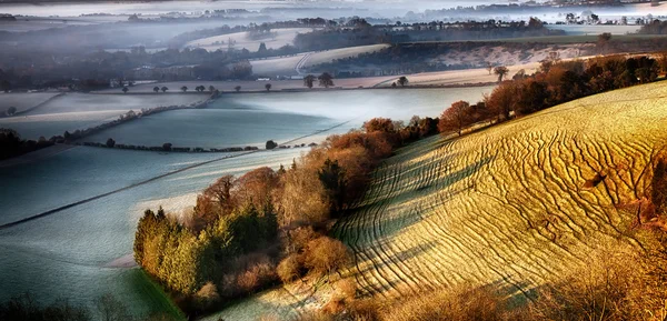 Dawn breaking over wrinkled hill - South Downs - UK — Stock Photo, Image