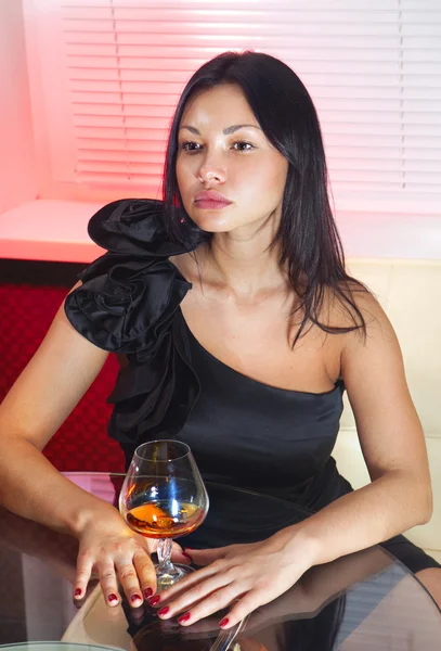 Woman with glass of peach-brandy — Stock Photo, Image