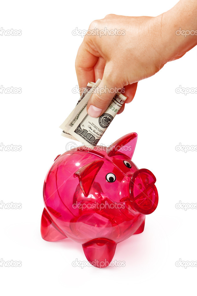 hand putting banknote into piggy bank