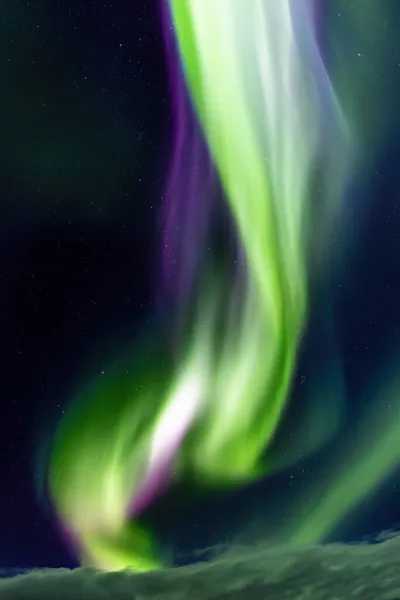 Northern lights, Aurora Borealis corona in the night sky, Iceland. These colourful curtains of dancing lights can illuminate the night sky in shades of green, blue and magenta.