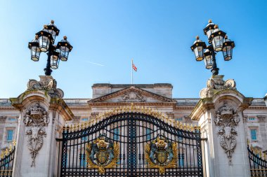 London, UK - 26 March 2022: The Dominion Gate entrance to Buckingham Palace, London, with coat of arms and ornate lanterns. Residence to Queen Elizabeth II, who has reigned for 70 years. clipart