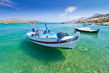 Fishing boats at the coast of Crete clipart