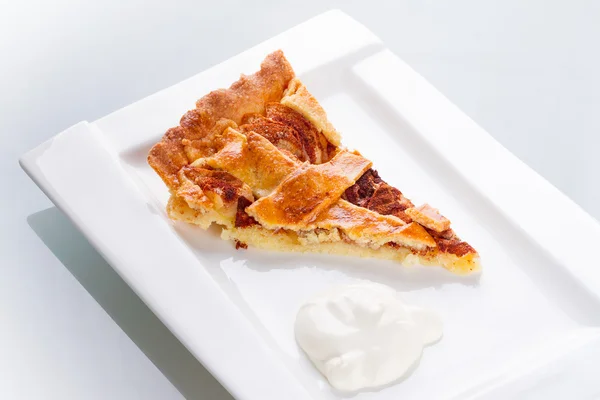 Piece of apple tart and cream — Stock Photo, Image