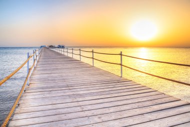 Pier on Red Sea in Hurghada at sunrise clipart