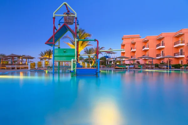 Swimming pool of tropical resort in Hurghada at night — Stock Photo, Image