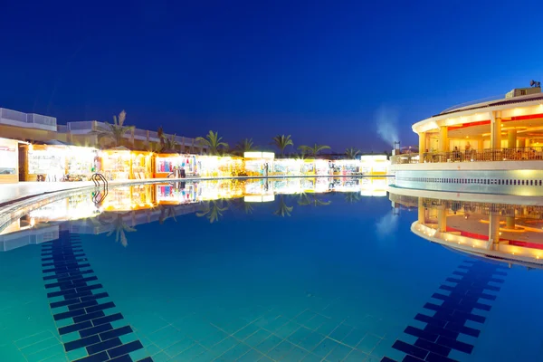 Swimming pool of tropical resort in Hurghada at night — Stock Photo, Image