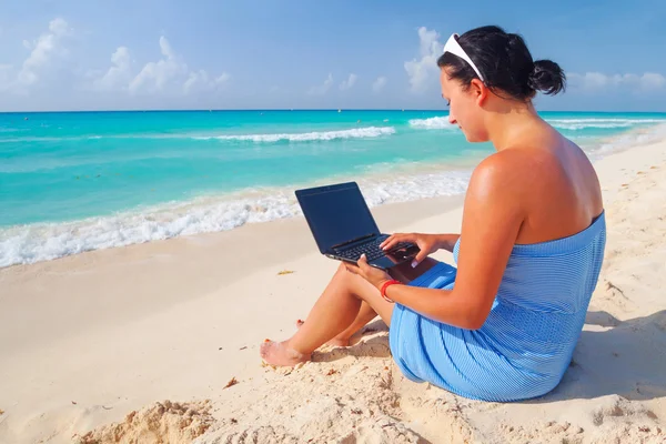 Donna con computer portatile seduto al mare dei Caraibi — Foto Stock