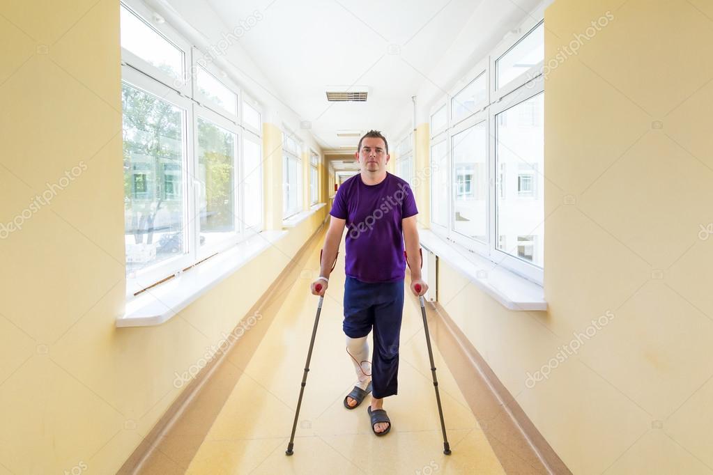 Man walks on crutches
