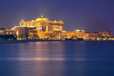 Luxury Emirates Palace hotel in Abu Dhabi at night clipart
