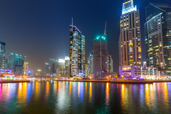 DUBAI, UAE - 31 MARCH 2014: Skyscrapers of Dubai Marina at night, UAE. Dubai Marina is a district in Dubai with artificial canal city who accommodates more than 120,000 people at Persian Gulf.