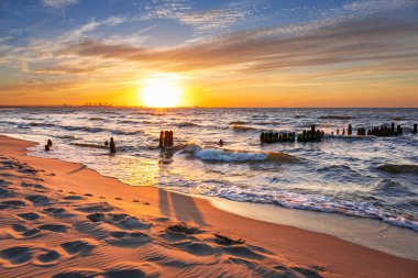 Sunset on the beach at Baltic Sea clipart