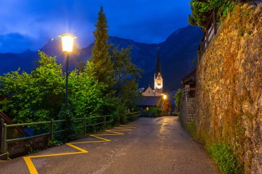 Hallstatt village in Alps at night clipart
