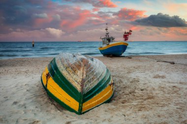 Amazing sunset with fishing boats at the beach of Baltic Sea in Sopot, Poland clipart