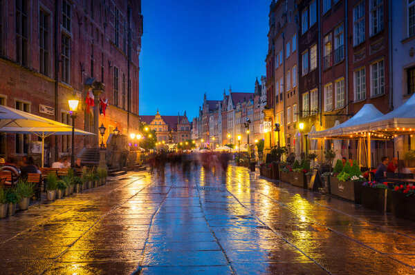Gdansk, Poland - June 20, 2020: People in the historic old town of Gdansk at dusk, Poland.