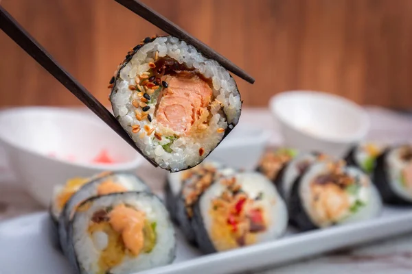 Sushi Roll Salmon Held Chopsticks — Stock Photo, Image