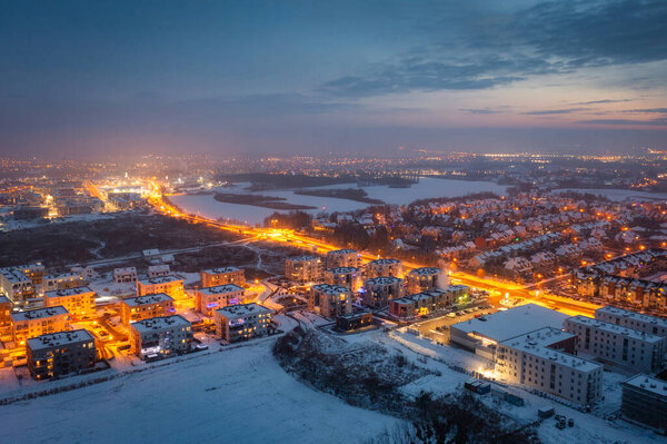 Aerial landscape of small village at dusk covered with fresh snow