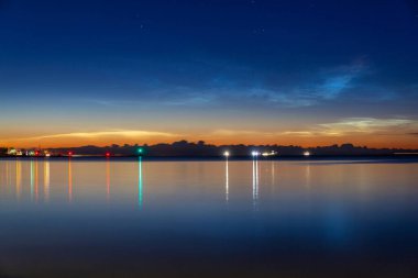 Noctilucent clouds over the Gdynia cityscape at night. Poland