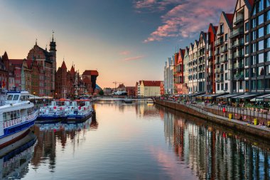 Gdansk, Poland - July 4, 2022: Beautiful architecture of the Main Town of Gdansk with the historic Crane over the Motlawa River at sunset, Poland.