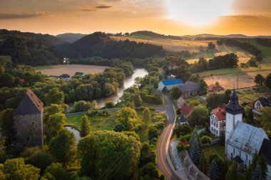 Historical Siedlecin town illuminated by the setting sun in the Bobr Valley Landscape Park, Lower Silesia. Poland