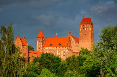 The castle and cathedral in Kwidzyn illuminated by the setting sun, Poland
