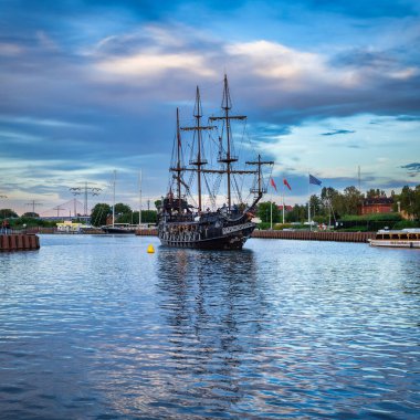 Gdansk, Poland - July 29, 2022: Pirate sailing ship with tourists on board in the waters of the Motlawa river in Gdansk, Poland.