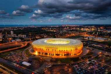 Gdansk, Poland - August 31, 2022: Aerial landscape with amber shape Stadium by the Baltic Sea in Gdansk at dusk, Poland.