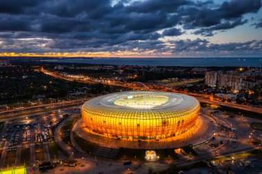 Gdansk, Poland - August 31, 2022: Aerial landscape with amber shape Stadium by the Baltic Sea in Gdansk at dusk, Poland.