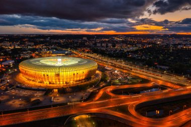 Gdansk, Poland - August 31, 2022: Aerial landscape with amber shape Stadium by the Baltic Sea in Gdansk at dusk, Poland.