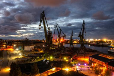 Gdansk, Poland - September 2, 2022: Gdansk shipyard scenery (Stocznia or 100cznia in polish means shipyard) with retro-lighted clubs and bars at dusk, Poland.