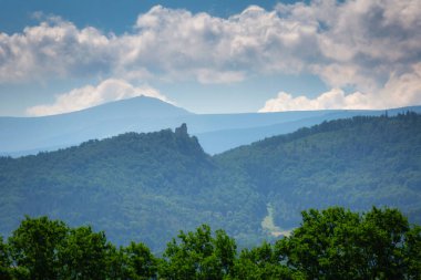 Chojnik Castle over the Sniezka Peak in the Giant Mountains at sunny day. Poland