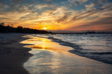 Sunset on the beach of the Baltic Sea in Gdansk, Poland
