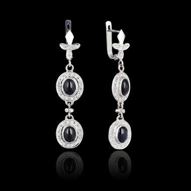 White gold earrings isolated on black background clipart