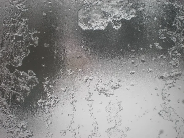 Wet snow on glass — Stock Photo, Image