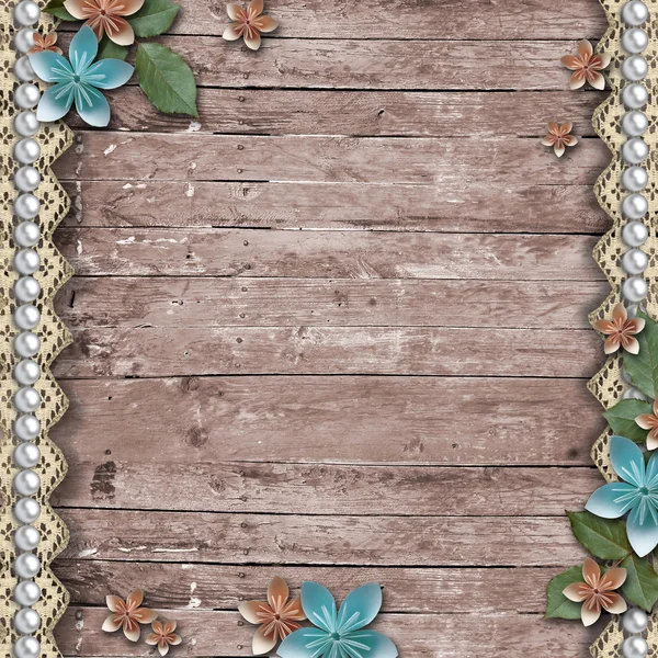 Old wooden background with a flowers, pearls and lace — Stock Photo, Image