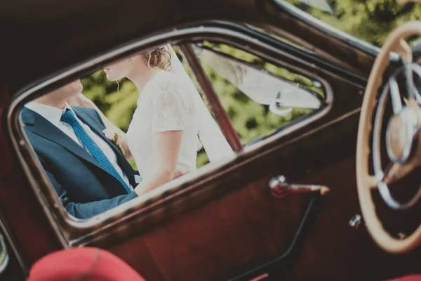 Bruden och brudgummen vid bröllop bil — Stockfoto