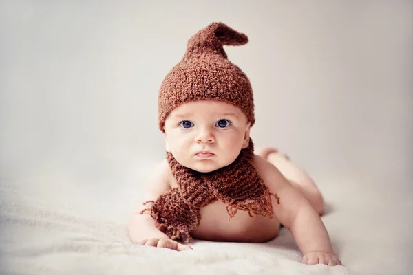 Newborn baby in a cap and scarf — Stock Photo, Image
