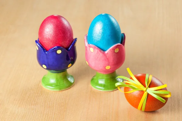 Colored easter eggs in egg cups — Stock Photo, Image